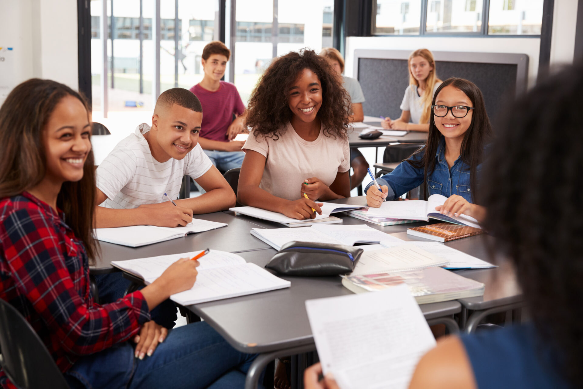 High,School,Kids,Looking,To,Teacher,Sitting,At,Their,Desk